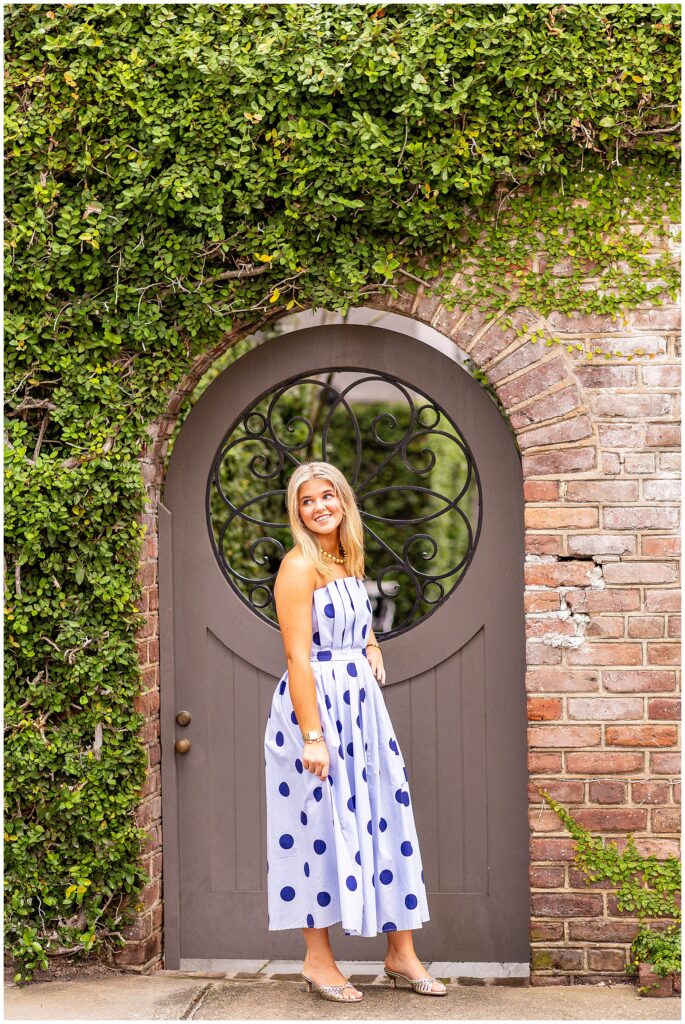 Charleston senior photographer captures timeless portraits of a senior in a blue dress on Tradd Street at sunrise in Historic Charleston.