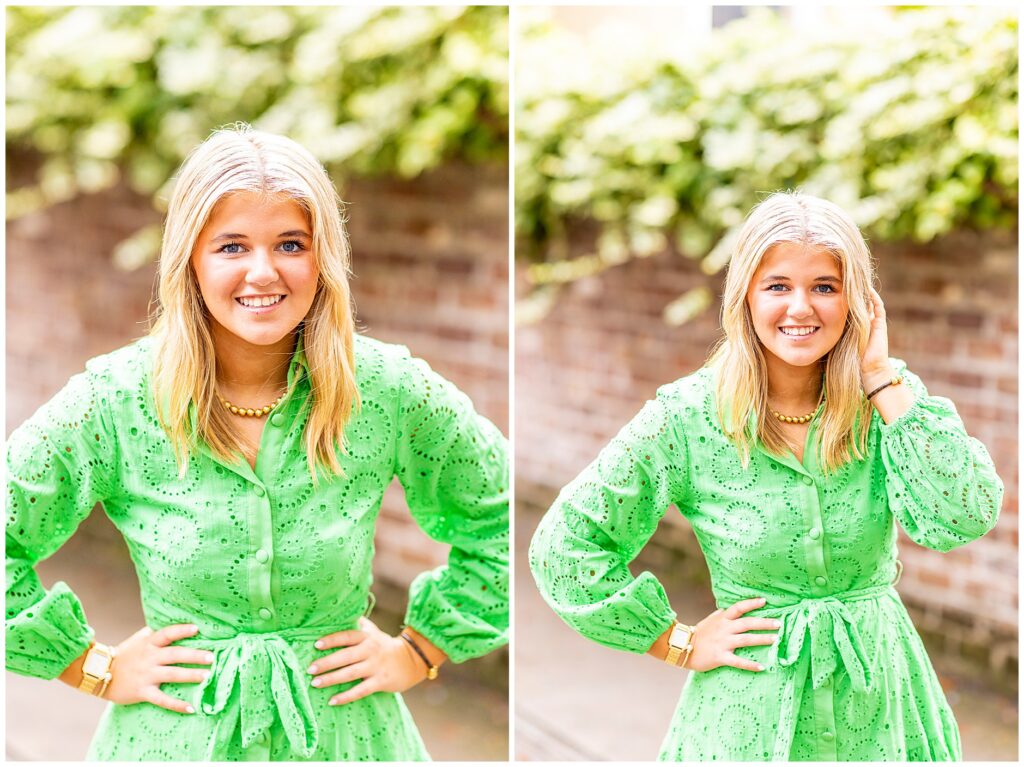 Elegant senior photo of a girl in a green dress smiling softly in front of Charleston’s historic homes.
