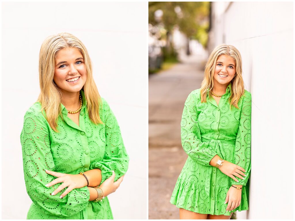 Chic senior portraits in Charleston SC featuring a senior girl in a green dress surrounded by colorful homes and warm light.
