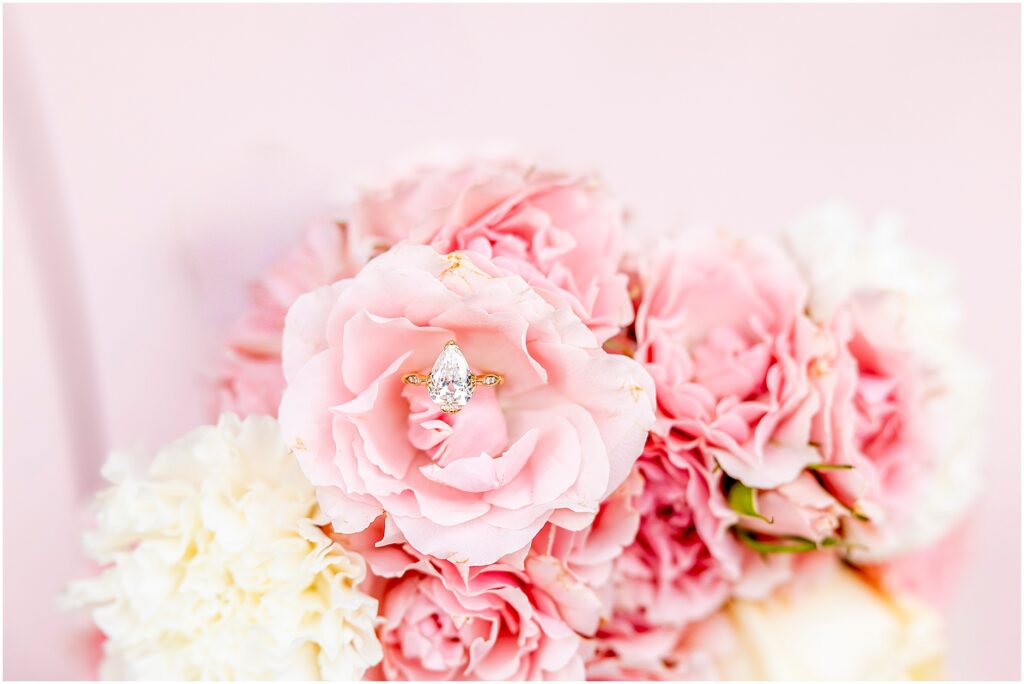 Detail shot of the engagement ring against The Pink Figgy’s pink backdrop.