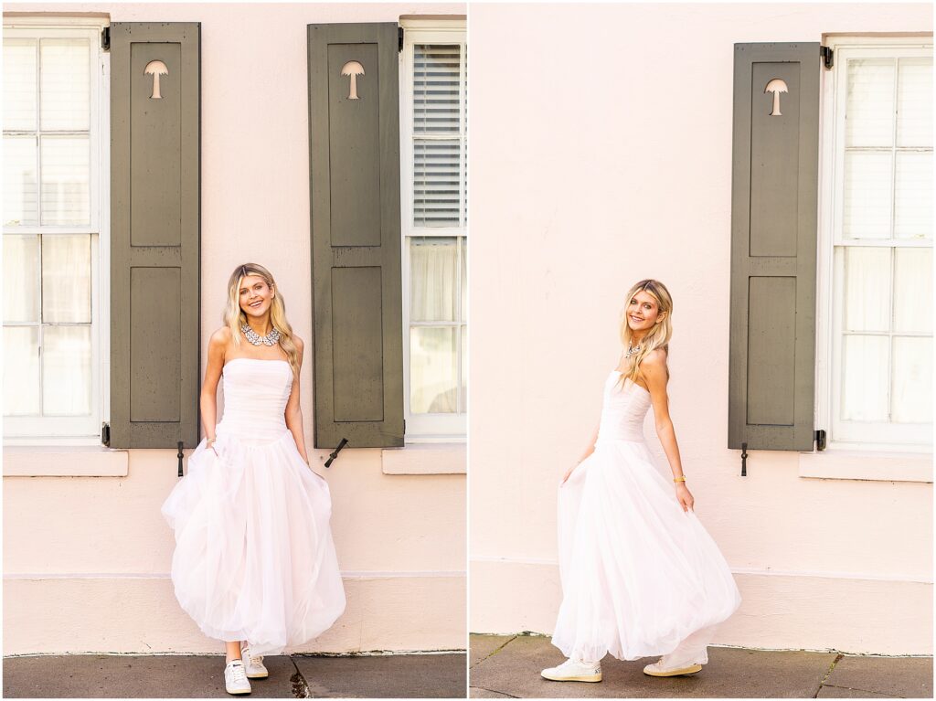 Full-length portraits of Bella in front of a pink historic home on Rainbow Row for her Charleston senior session.