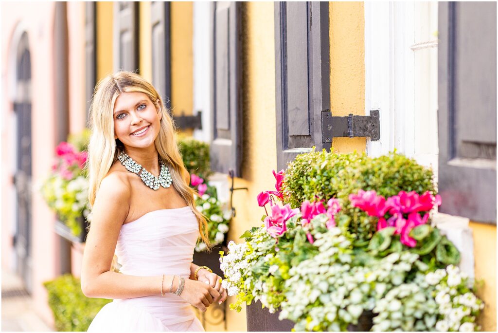 Close-up of Bella’s eyes and smile in soft morning light near Rainbow Row during her senior session.