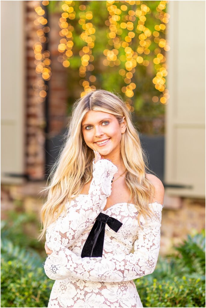 Bella walking toward the camera along a quiet Tradd Street sidewalk for her senior session.