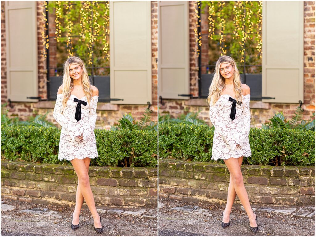 Bella seated on steps, hands clasped, looking off into the distance on Rainbow Row during her senior portraits.