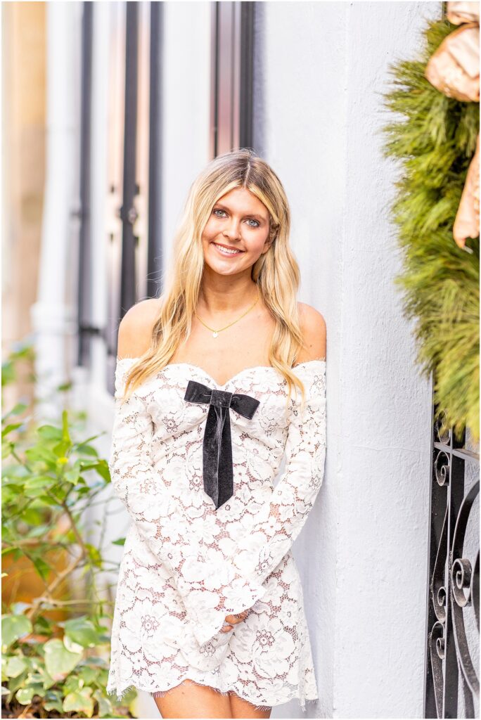 Bella twirling on a cobblestone street near Tradd Street with her dress flowing during her senior session.