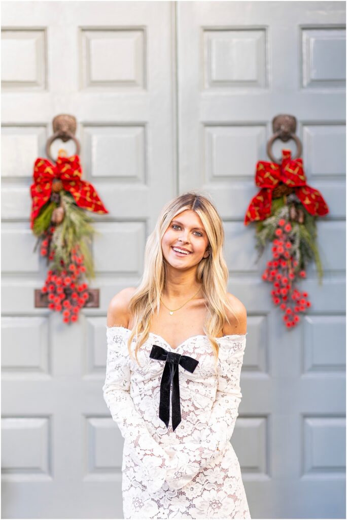 Full-length portrait of Bella under a tree along Rainbow Row with dappled morning light.