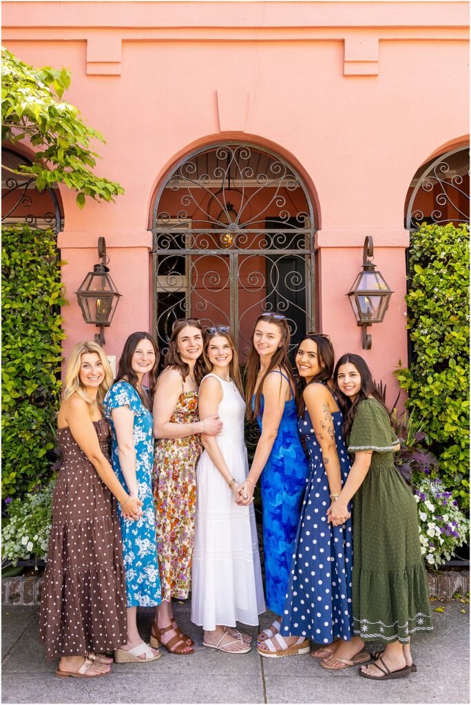 Bride and her girls posing in front of iconic Rainbow Row for bachelorette photos
