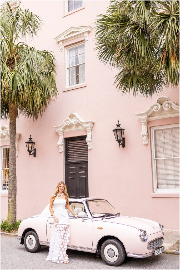 Charleston senior photos at the Mills House Hotel with pink walls, palm trees, and The Pink FIggy