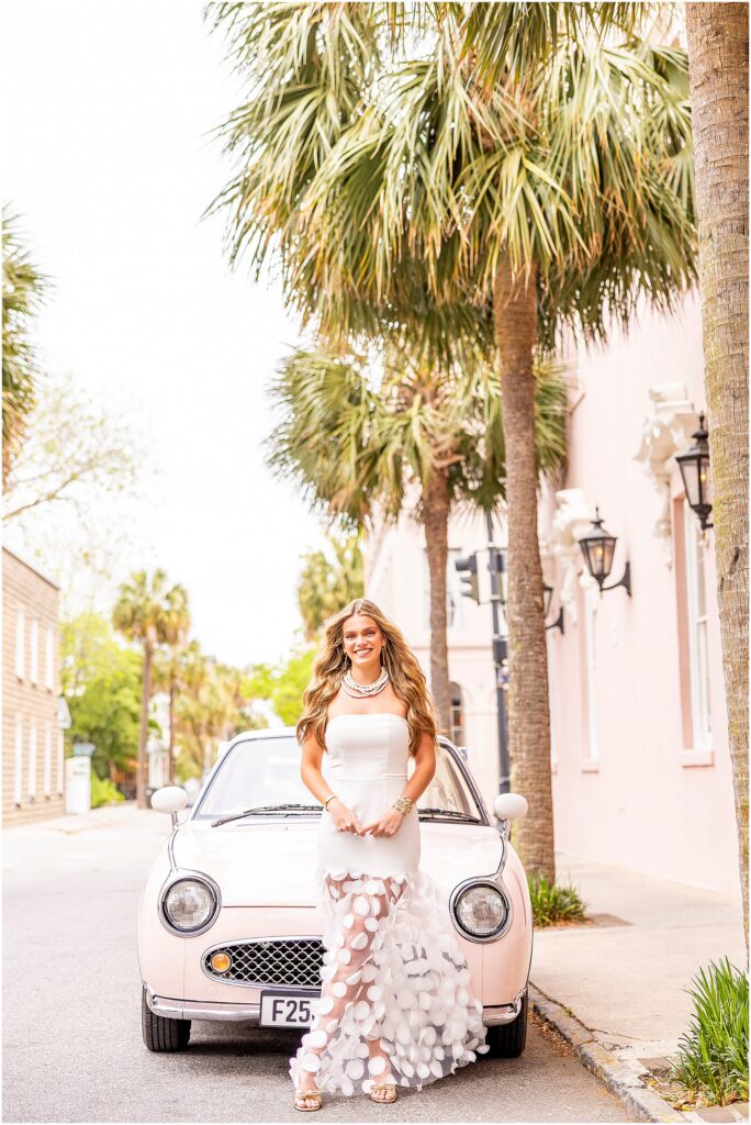 High school senior posing in front of The Pink Figgy parked outside of the Mills House Hotel, Charleston SC