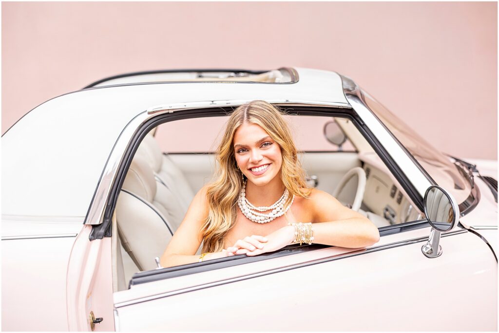 Timeless senior portrait of a high school girl sitting inside The Pink Figgy outside of The Mills House Hotel in Charleston, SC