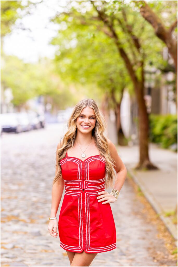 Editorial style senior portrait on cobblestone street in Charleston South Carolina