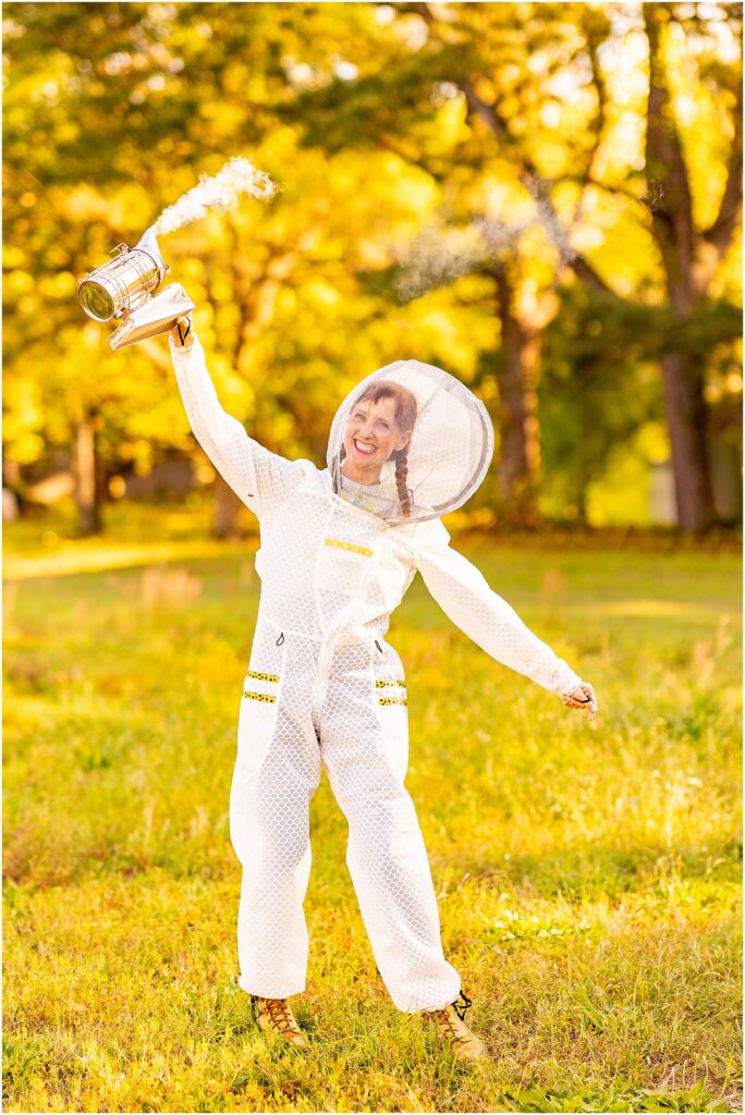 Joyful lifestyle brand photos of beekeeper, Jenna York, wearing protective suit in Charleston, SC