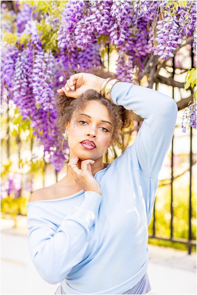 Charleston senior photographer capturing spring photos with wisteria in bloom