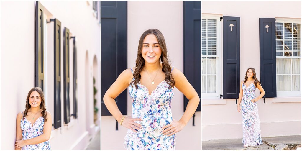 Senior photos in front of the ionic pink house on Rainbow Row with black shutters and a palmetto tree
