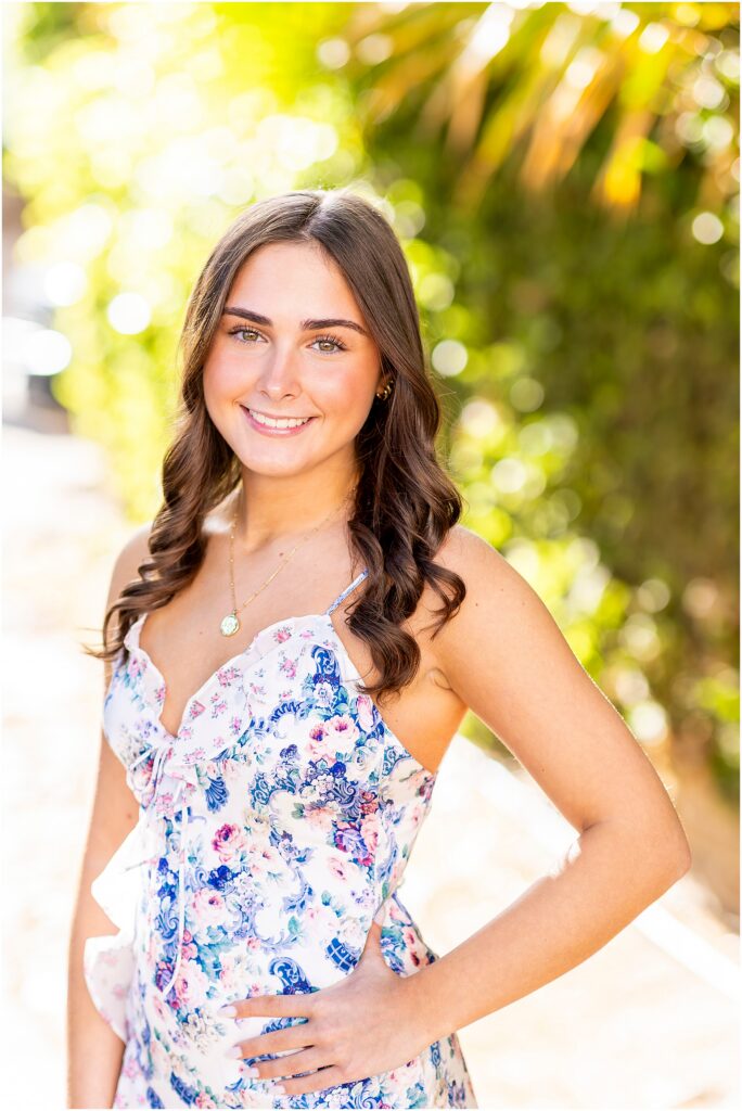 Timeless senior photo of a girl in Charleston with greenery around her and glowy light draping over her