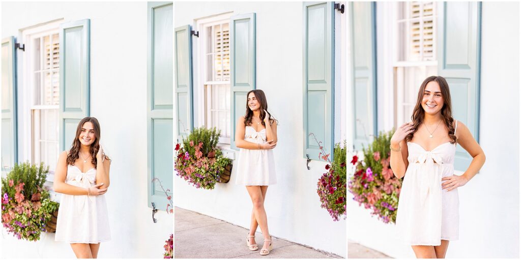 Senior photos on Rainbow Row in Charleston with a pastel blue home as the backdrop