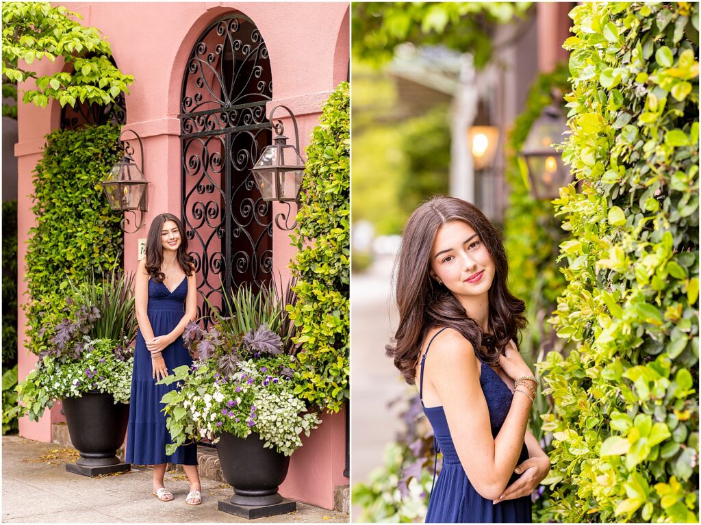High school senior posing in front of colorful houses with greenery on Rainbow Row Charleston SC