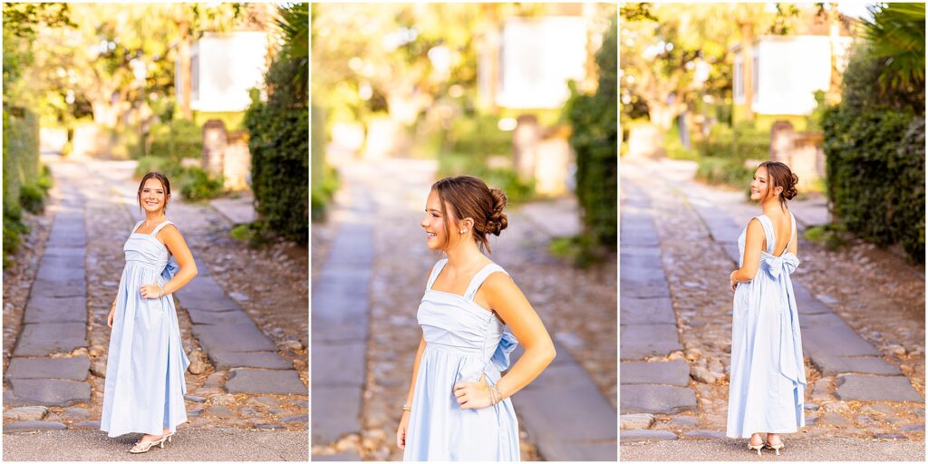 High school senior wearing a baby blue dress with a big bow in the back posing elegantly on Longitude Ln in Charleston SC