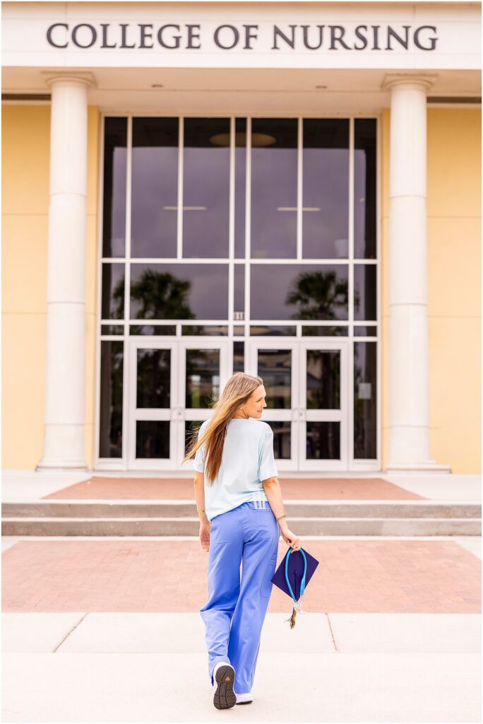 BSN graduate holding a stethoscope and syringes during graduation portraits at Charleston Southern University.