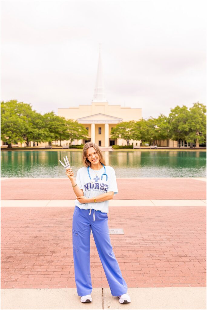 Senior posing at Charleston Southern University with the chapel and reflection pond as the background 