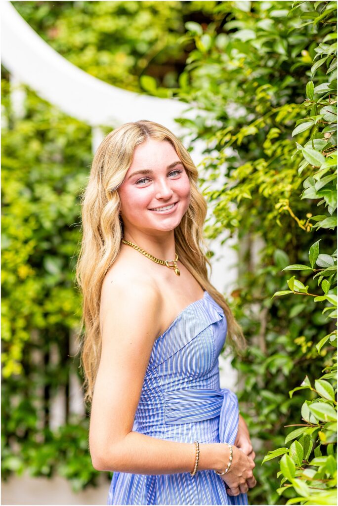 Charleston senior portrait with cobblestone streets and historic homes.