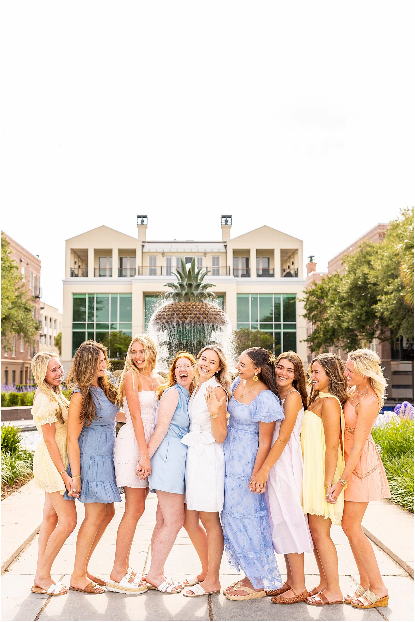 Bride and bridesmaids posing at the Pineapple Fountain in Charleston's Waterfront Park