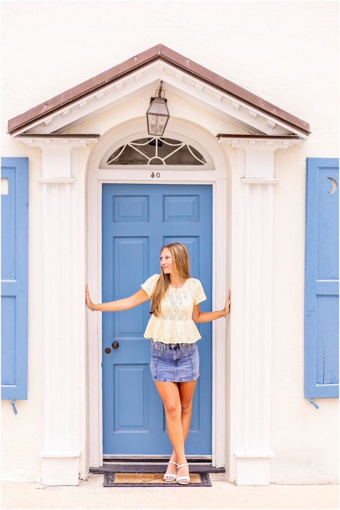 Charleston senior session at Rainbow Row featuring classic Lowcountry architecture and colorful historic homes