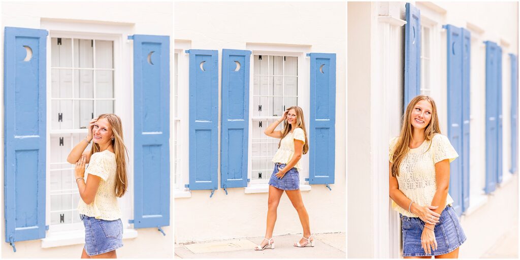 Charleston senior posing in front of the colorful homes of Rainbow Row during an evening downtown Charleston senior session
