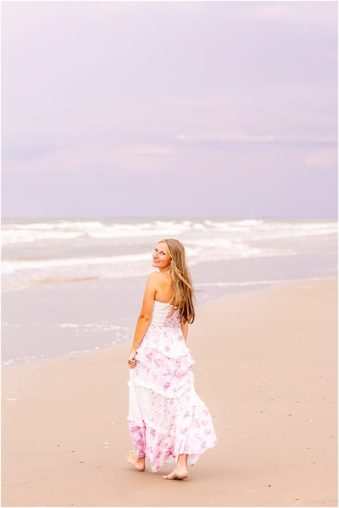 Senior portrait at Isle of Palms featuring soft ocean waves and warm coastal light
