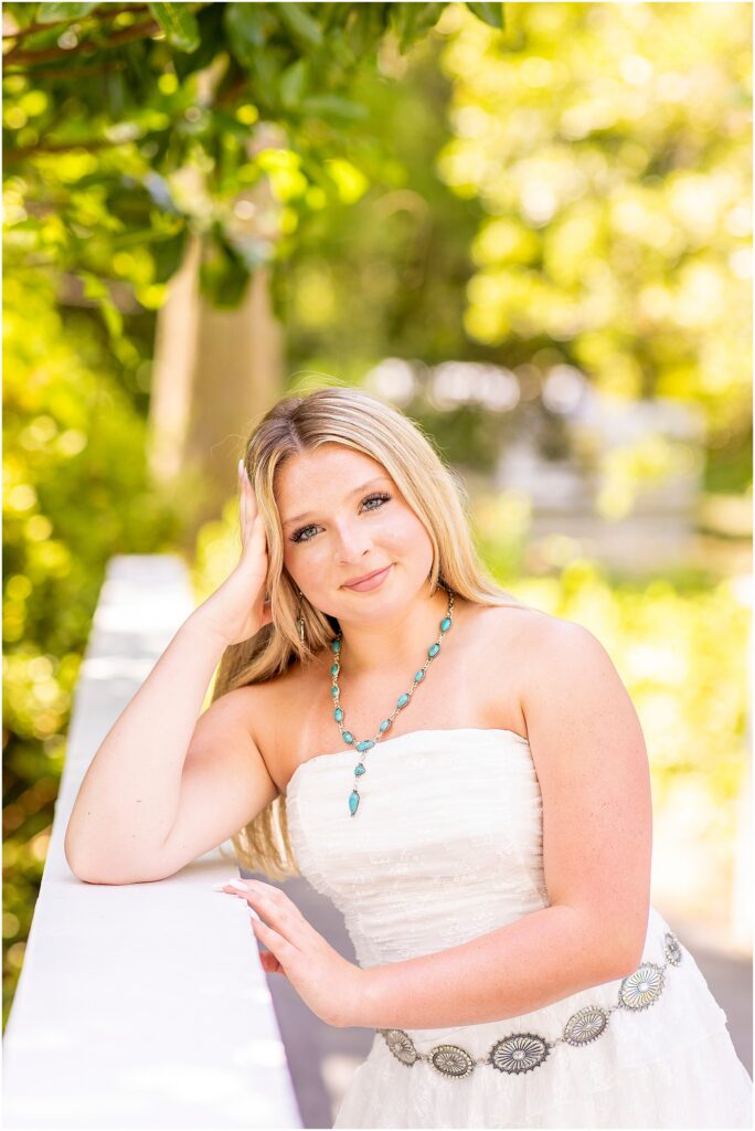 Charleston senior photography featuring peaceful garden pathways and Spanish moss.