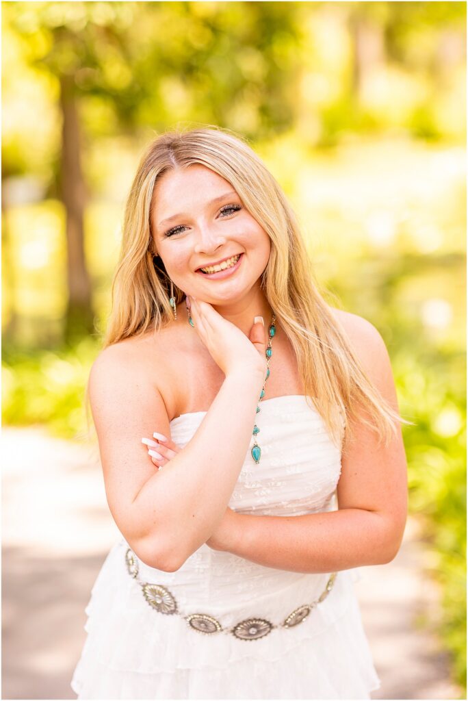 Summer senior photos surrounded by moss-draped trees near Charleston, South Carolina.