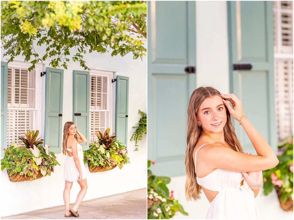 High school senior posing in front of Rainbow Row during a summer senior session in downtown Charleston.