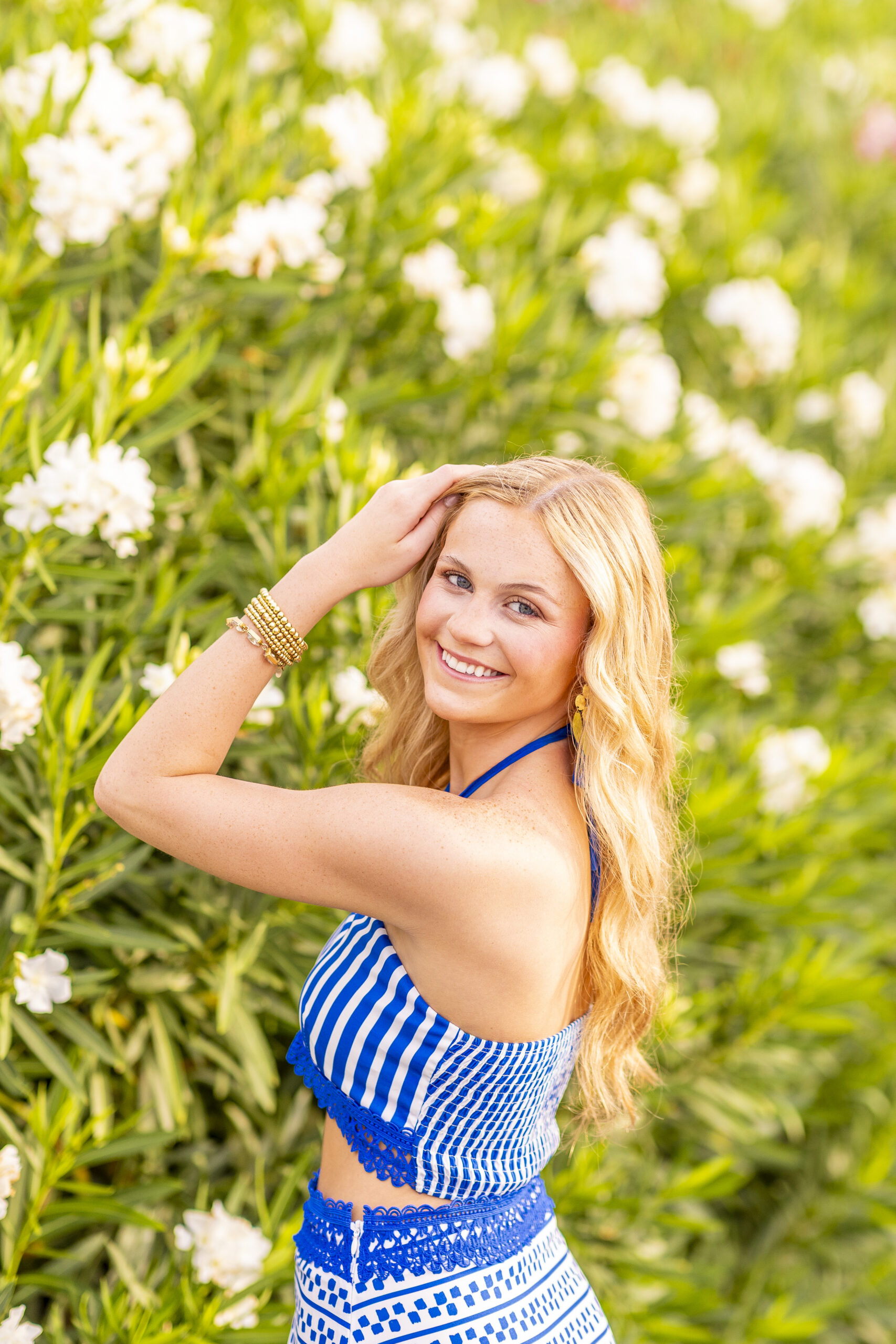 Senior celebrating graduation at The Battery with historic mansions and waterfront views in Charleston