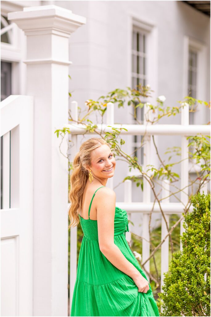 Downtown Charleston senior session with a graduate in a green dress on the historic streets of Charleston