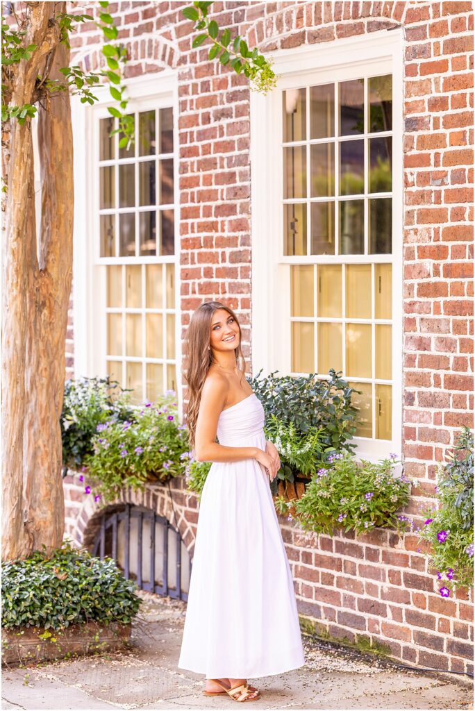 Charleston senior portraits featuring a Class of 2027 senior surrounded by historic homes and lush greenery in South of Broad