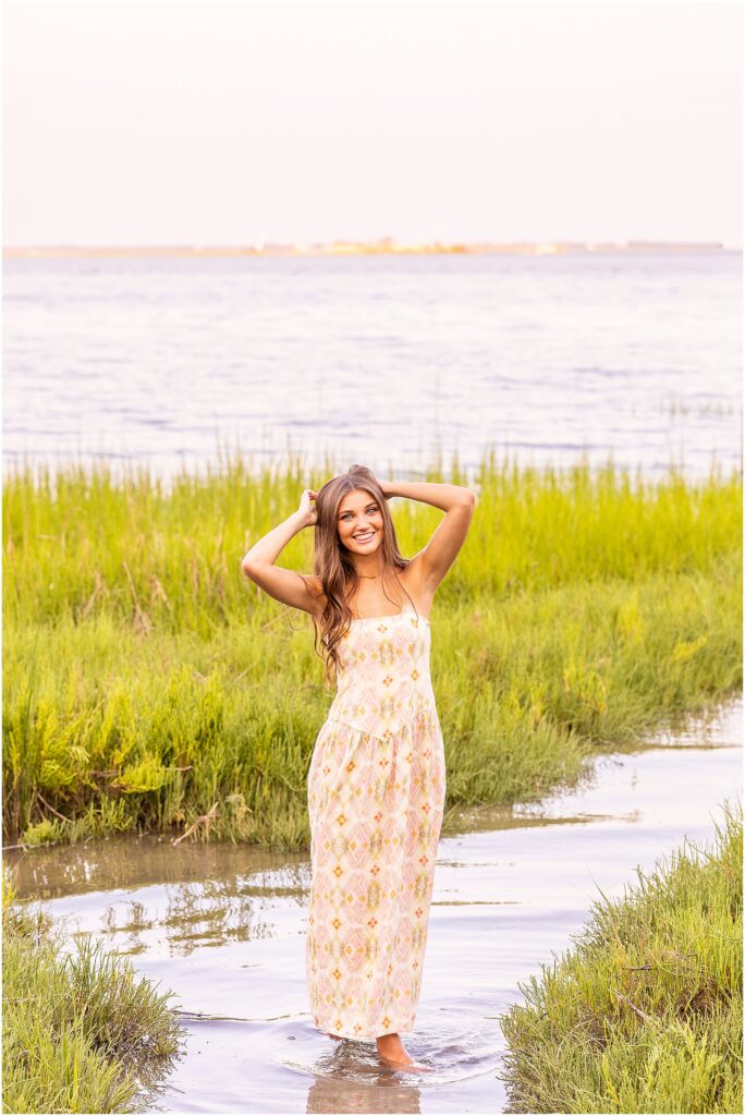 Class of 2027 senior posing with Charleston Harbor and the Lowcountry waterfront in the background at Waterfront Park