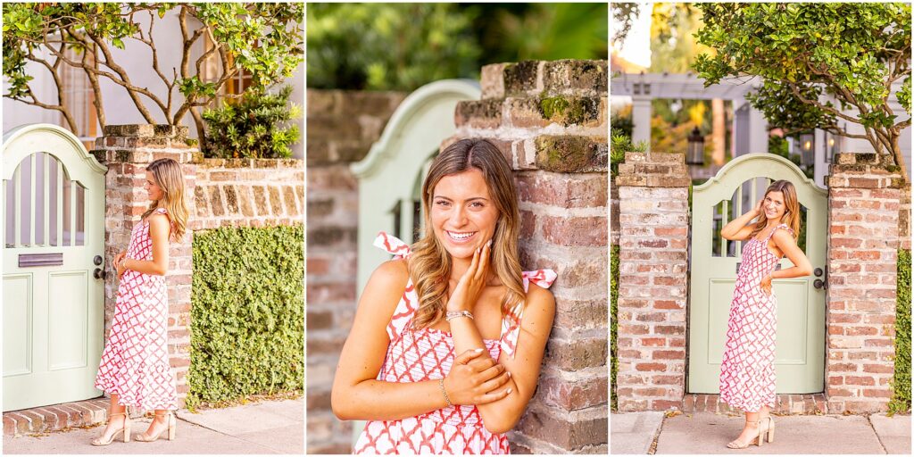 Senior girl posing along Rainbow Row in Charleston South Carolina wearing a white and red dress
