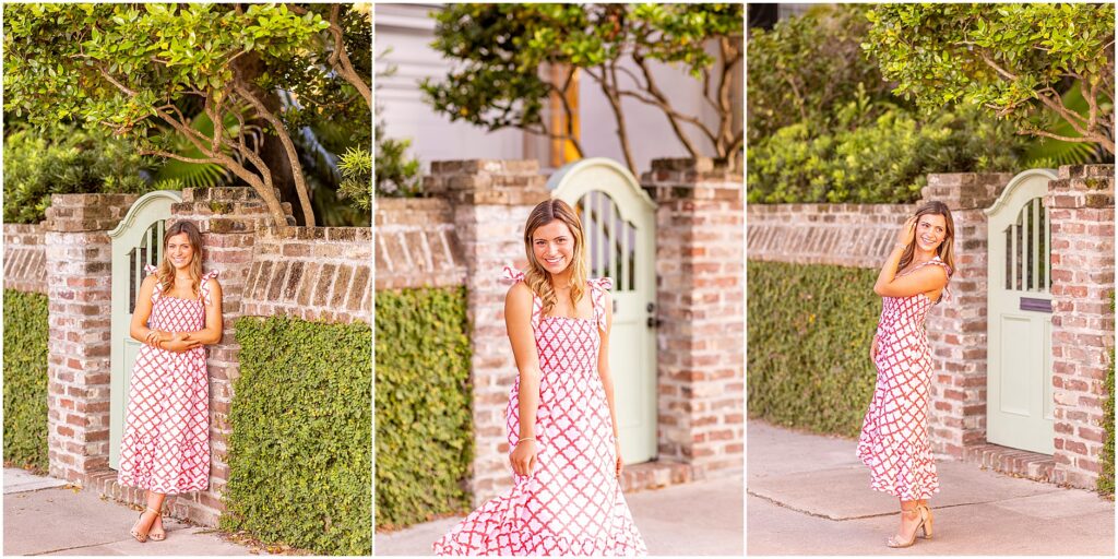 Senior girl walking along Rainbow Row in a white and red dress during her Charleston senior session