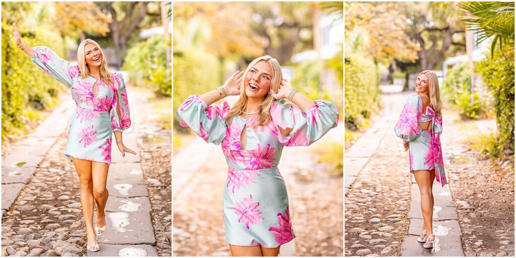 Senior girl walking through cobblestone streets in South of Broad in a blue and pink long-sleeve dress during her Charleston senior session