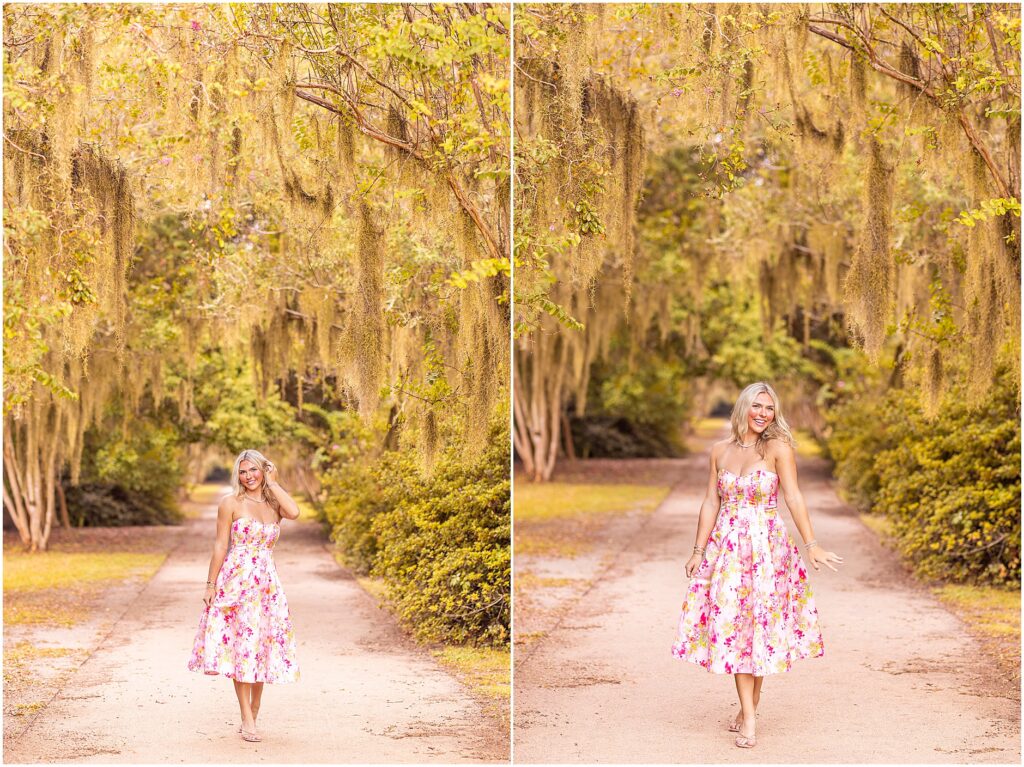 Senior girl posing in a bright pink dress among the draping Spanish moss of Hampton Park during a Charleston senior photography session