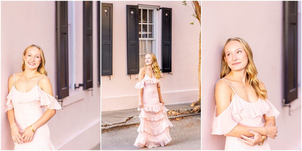 Senior girl in a pretty pink LoveShackFancy dress surrounded by the pastel homes of Rainbow Row in Charleston SC
